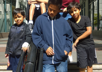 A group of kids standing on steps with their musical instruments.