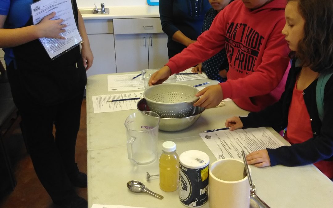 A group of people standing around a table.