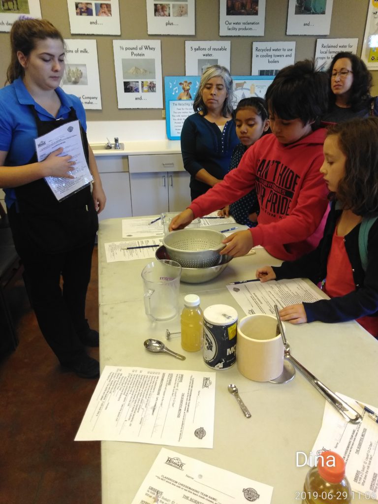 A group of people standing around a table.