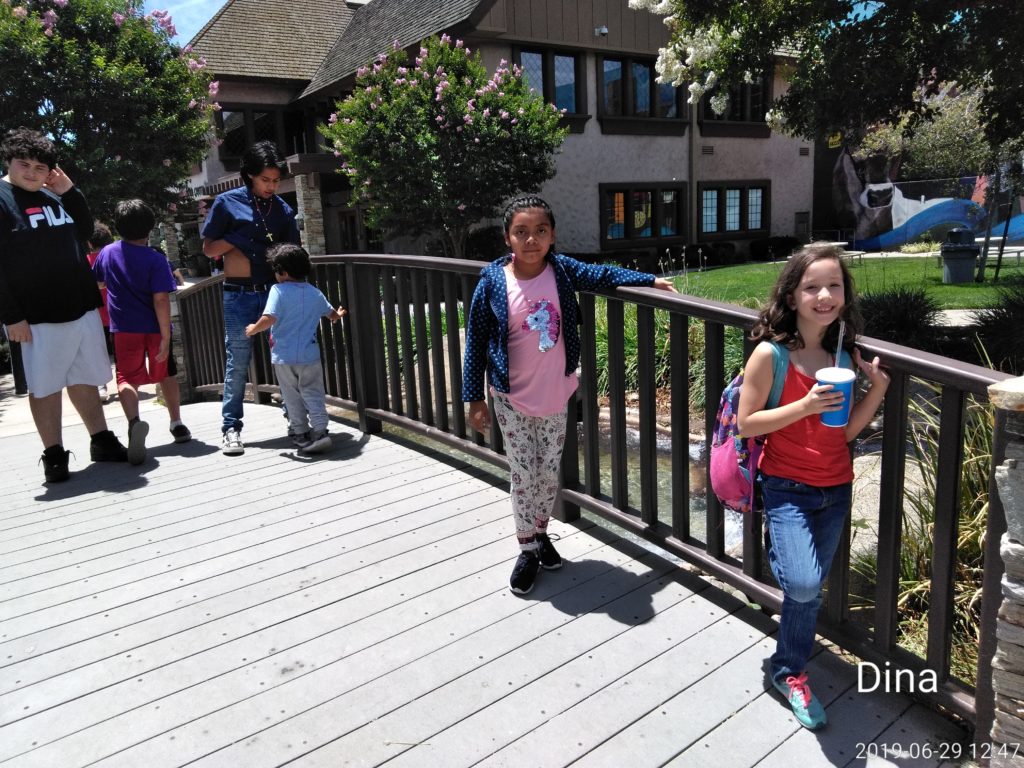 A group of children standing on the side walk